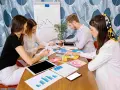 Equipo discutiendo estrategias de marketing digital, con iconos de redes sociales y gráficos. Parecen estar planeando una campaña de "fake out of home".