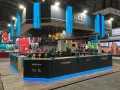 Moderno stand para ferias con iluminación azul, mostrando áreas como Medicina y Fisioterapia. Ideas de stand para ferias que inspiran.