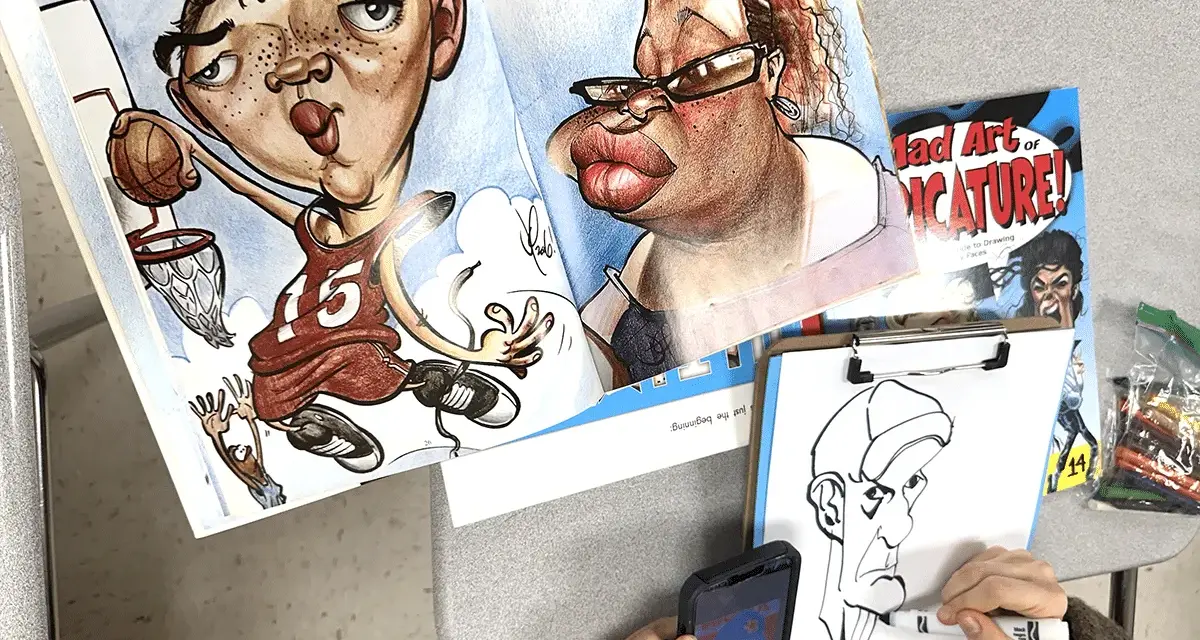 Un libro muestra qué es una caricatura con dibujos exagerados de un jugador de baloncesto y una mujer. Alguien dibuja otra caricatura.